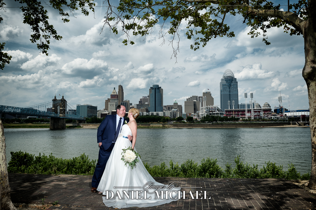 Couple standing in front of river and city